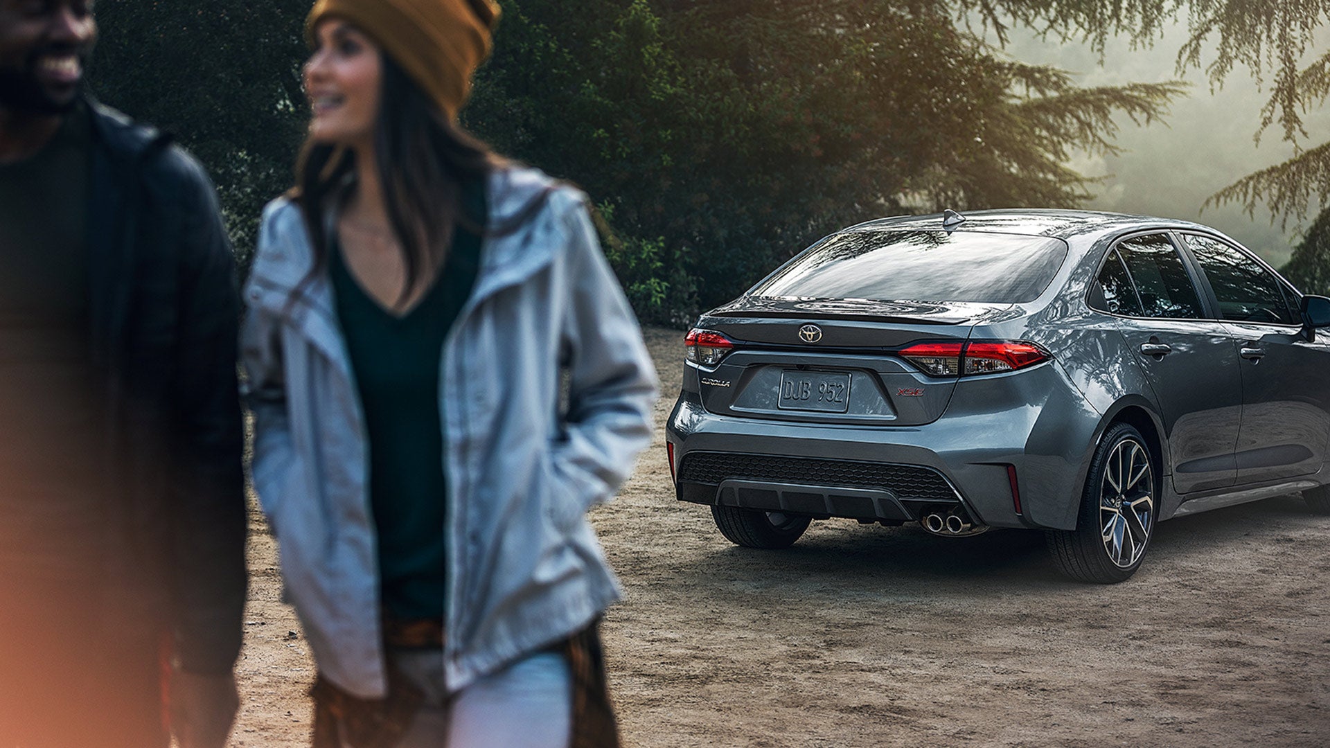 how to buy or lease a new Toyota at Fiore Toyota of Hollidaysburg | Grey MY20 Corolla Rear Parked Couple Walking
