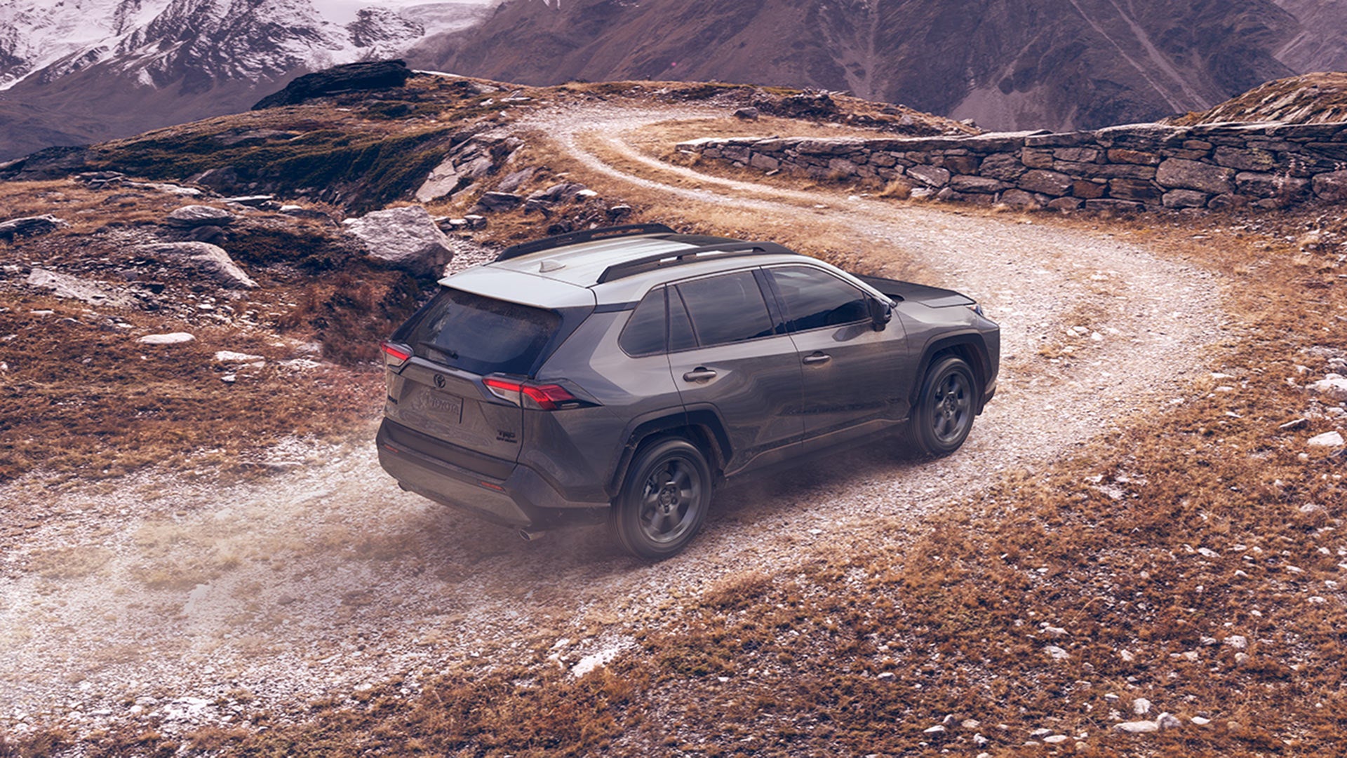 how to buy or lease a new Toyota at Fiore Toyota of Hollidaysburg | Black MY20 RAV4 Rear Driving up Mountain Path