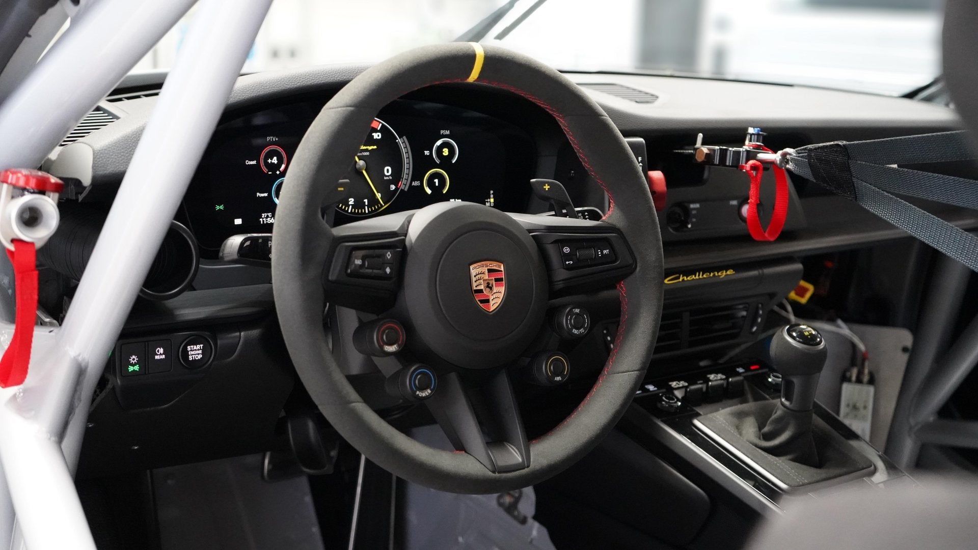 Porsche 911 Challenge cockpit with steering wheel, adjustable controls, and roll cage