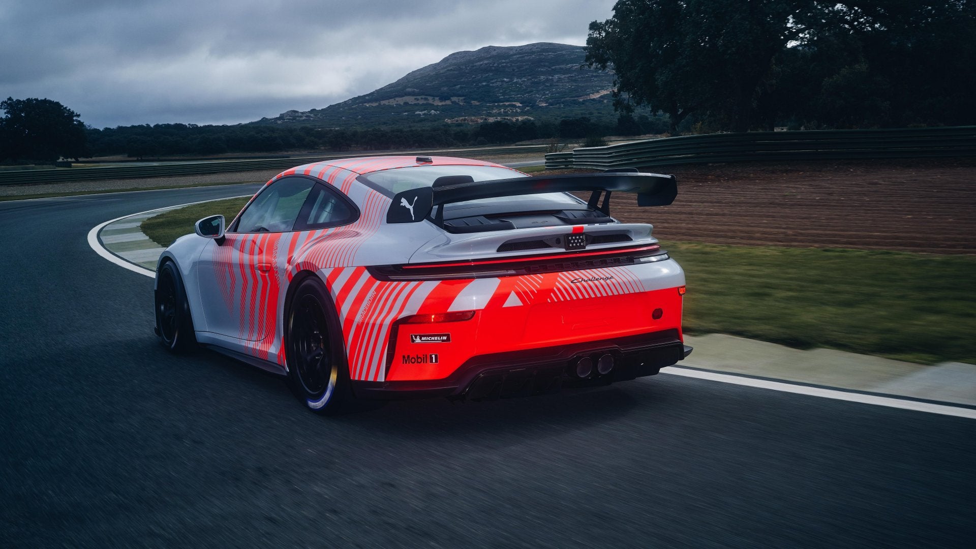 Rear three-quarter view of the Porsche 911 Challenge showing its racing rear wing